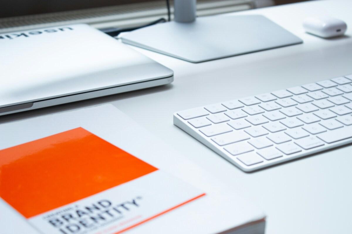 Branding book next to computer